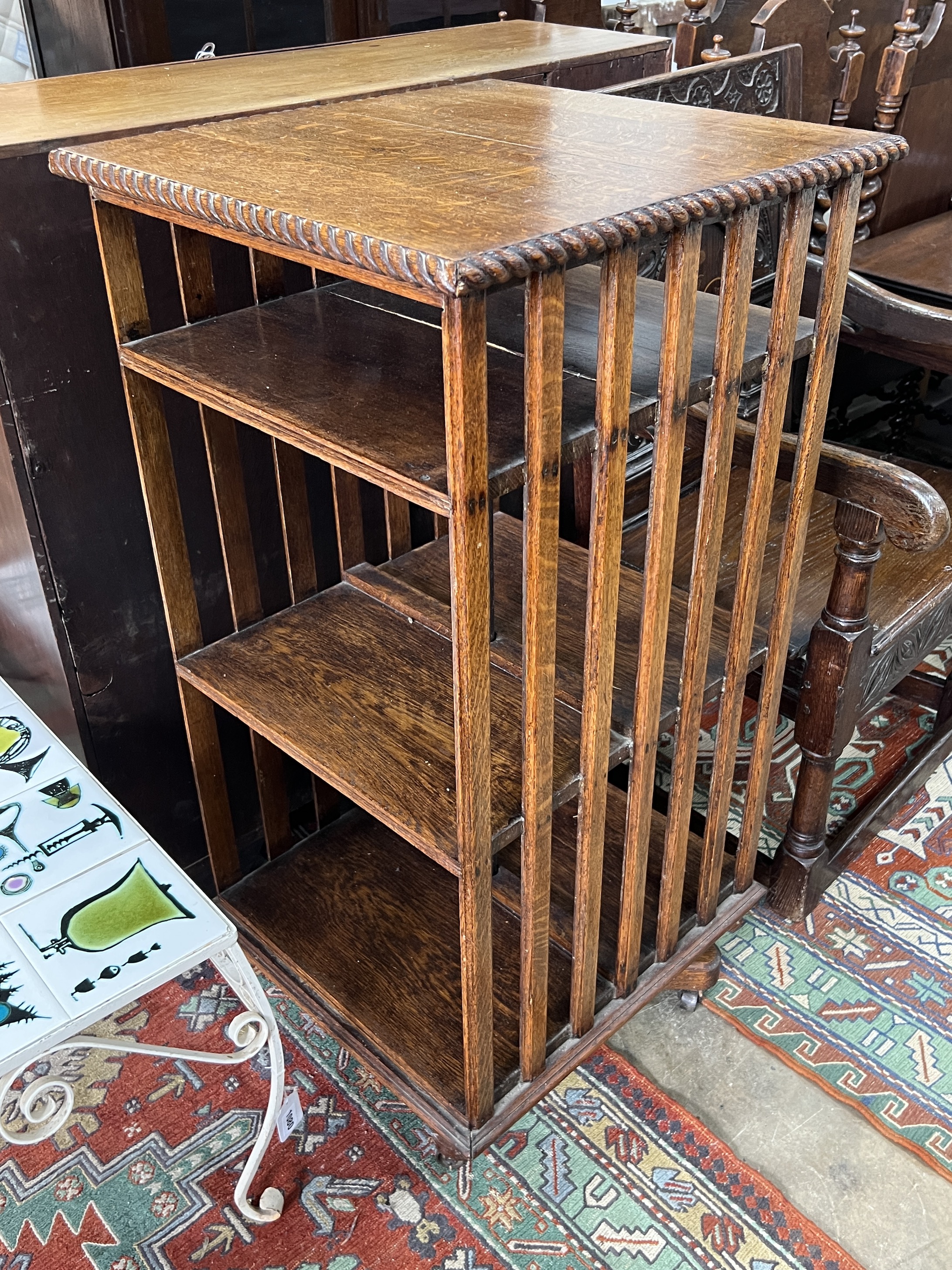 An early 20th century oak three tier revolving bookcase, width 51cm, depth 53cm, height 105cm